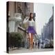 Long Hair Woman with short skirt, lace top and sandals walking up street in "New York Look" fashion-Vernon Merritt III-Premier Image Canvas
