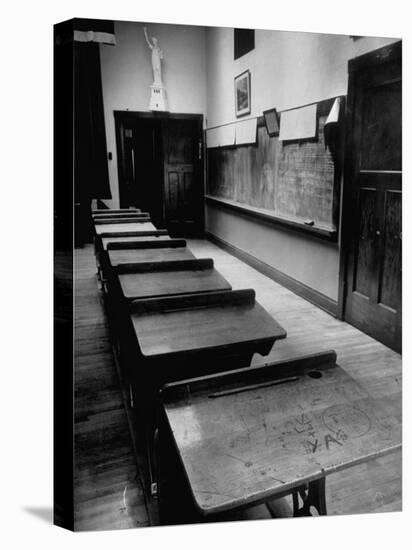 Looking Down Row of Empty Scarred Old Fashioned Desks in Schoolroom-Walter Sanders-Premier Image Canvas