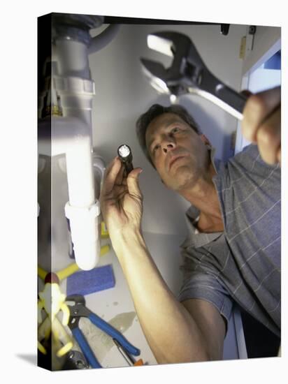 Low Angle View of a Young Man Checking the Plumbing with a Flashlight-null-Premier Image Canvas