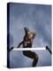 Low Angle View of a Young Man Jumping over a Hurdle-null-Premier Image Canvas