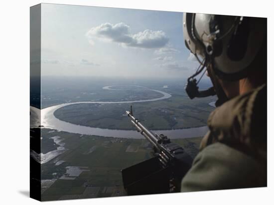 Machine Gunner Scanning For Hostiles While His Helicopter is on Patrol over the Mekong Delta-Larry Burrows-Premier Image Canvas