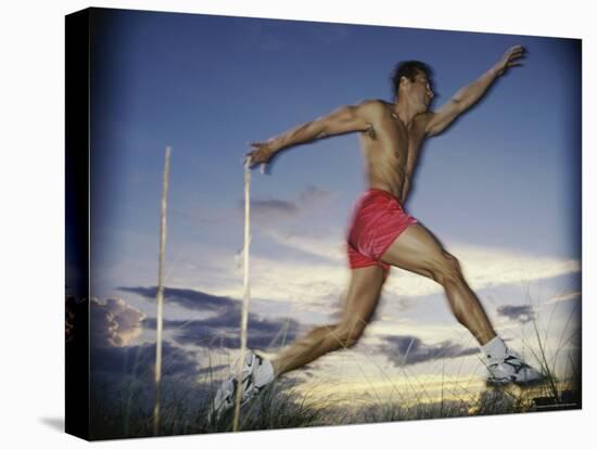 Male Jogger Leaping in a Field-null-Premier Image Canvas