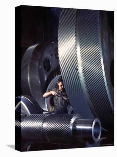 Man Dwarfed by Gigantic Gears He is Working on for the Navy, at General Electric Plant in US-Dmitri Kessel-Premier Image Canvas