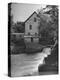 Man Fishing Beside a Waterfall and a 100 Year Old Mill-Bob Landry-Premier Image Canvas