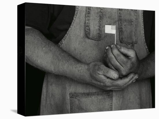 Man Holding Small American Flag-Bob Rowan-Premier Image Canvas