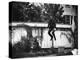 Man in a Suit and Bowler Hat Jumping in the Air in a Backyard in Brooklyn, Ny-Wallace G^ Levison-Premier Image Canvas