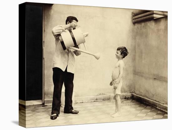 Man Is Sprinkling Boy with Water from Watering Can, 20th Century-Andrew Pitcairn-knowles-Premier Image Canvas