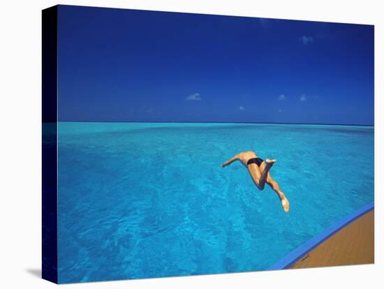 Man Jumping into Tropical Sea from Deck, Maldives, Indian Ocean-Papadopoulos Sakis-Premier Image Canvas