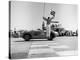 Man jumping waving checkered flag-H^ Armstrong Roberts-Stretched Canvas