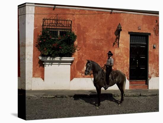 Man on Horse in Front of a Typical Painted Wall, Antigua, Guatemala, Central America-Upperhall-Premier Image Canvas