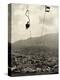 Man Riding Chair Lift Above Town-Jerry Cooke-Premier Image Canvas