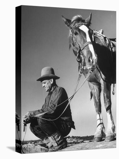 Man Sitting Holding His Horses Reins-Loomis Dean-Premier Image Canvas