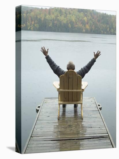 Man Sitting on a Dock with Arms Outstretched-null-Premier Image Canvas