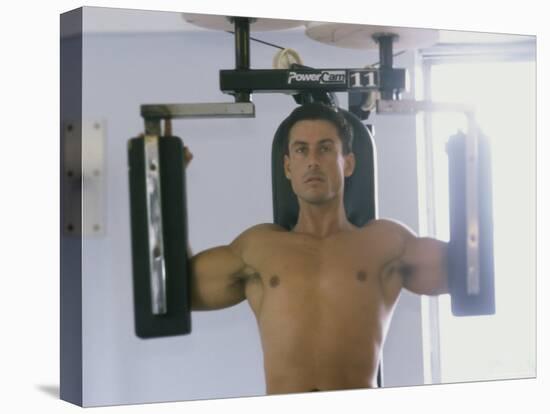 Man Using Exercise Machine-null-Premier Image Canvas