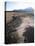 Man Walking on Dry Lake Bed with Llaima Volcano in Distance, Conguillio National Park, Chile-Aaron McCoy-Premier Image Canvas