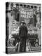 Man with Shopping Bags in Front of Million Dollar Theatre Emblazoned with God Bless America Banner-Bob Landry-Premier Image Canvas