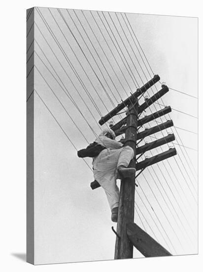 Man Working to Restore the Communication Lines after a Bombing Raid-Carl Mydans-Premier Image Canvas