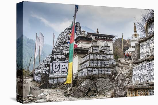 Mani Stones and prayer flags on a trail, Nepal.-Lee Klopfer-Premier Image Canvas