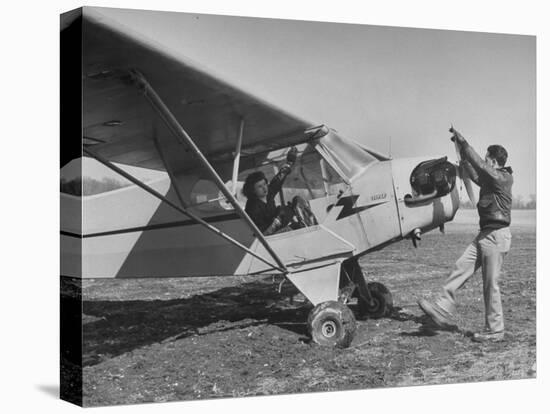 Marie Goerke Sitting in the Plane While the Instructor Kenny Garofalo Stops the Propellor-Bernard Hoffman-Premier Image Canvas