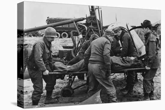 Medics Carry a Wounded U.S. Soldier Away from a Rescue Helicopter-null-Stretched Canvas