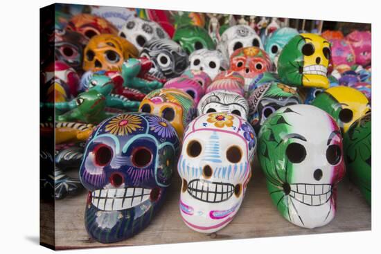 Mexico, Yucatan, Isla Mujeres, colorful ceramic calavera skulls for sale in market.-Merrill Images-Premier Image Canvas