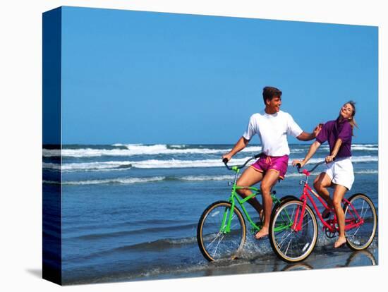 Middle-aged Couple Riding Bikes on the Beach-Bill Bachmann-Premier Image Canvas