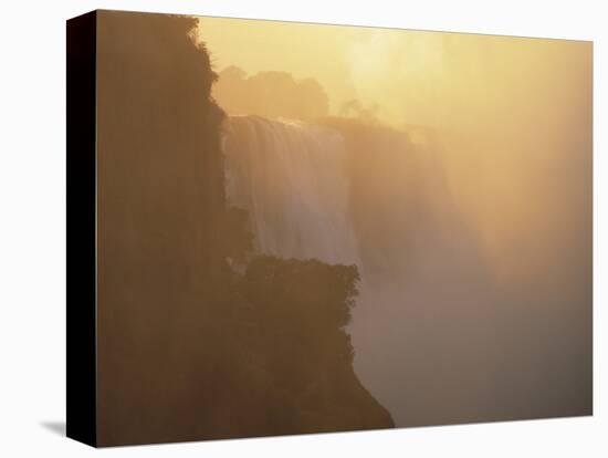 Mist Over Victoria Falls at Sunrise, Zimbabwe-Jim Zuckerman-Premier Image Canvas