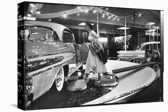 Model Gingerly Traversing Stepping Stones to Get to La Parisienne Pontiac Hard Top Car on Display-Walter Sanders-Premier Image Canvas