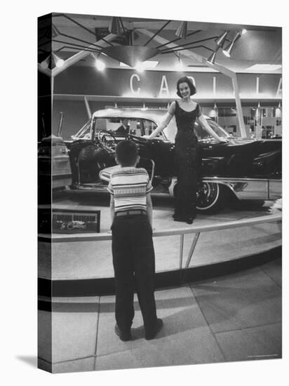 Model Posing Beside Cadillac Eldorado Captures Attention of Young Boy at National Automobile Show-Walter Sanders-Premier Image Canvas