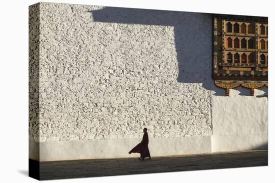 Monk walks through the courtyard of Rinpung Dzong Monastery, Bhutan.-Brenda Tharp-Premier Image Canvas