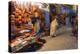 Morocco. An elderly man walks past tourist shops along a street in the blue city of Chefchaouen.-Brenda Tharp-Premier Image Canvas