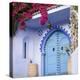 Morocco, Chefchaouen. Bougainvillea Blossoms Frame an Ornate Blue Door-Brenda Tharp-Premier Image Canvas