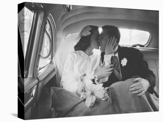 Mr. and Mrs. Thomas Beagan Jr. Kissing in Back of Car after their Wedding Ceremony-Ed Clark-Premier Image Canvas
