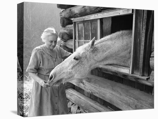 Mrs. Mary Breckenridge Runs the Frontier Nursing Service, Petting Her Horse-Eliot Elisofon-Premier Image Canvas