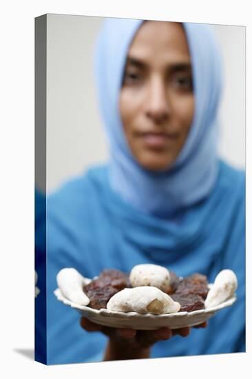 Muslim woman offering Ramadan pastries-Godong-Premier Image Canvas