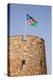 Namibia, Etosha National Park. Namibian flag flies over brick tower at park entrance.-Jaynes Gallery-Premier Image Canvas