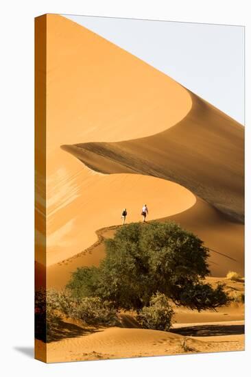 Namibia, Namib-Naukluft National Park, Sossusvlei. Two tourists climbing the scenic dune.-Ellen Goff-Premier Image Canvas