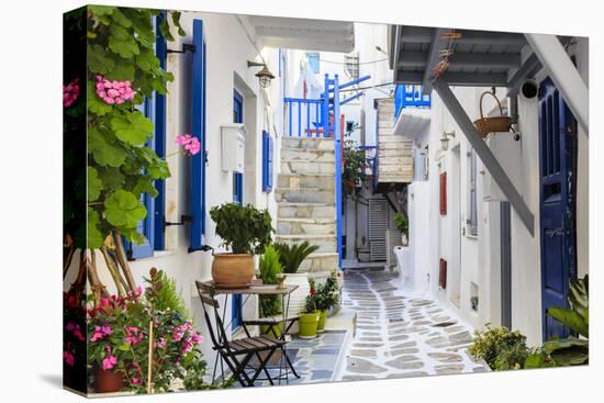 Narrow street, whitewashed buildings with blue paint work, flowers, Mykonos Town (Chora), Mykonos,-Eleanor Scriven-Premier Image Canvas