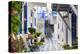 Narrow street, whitewashed buildings with blue paint work, flowers, Mykonos Town (Chora), Mykonos,-Eleanor Scriven-Premier Image Canvas