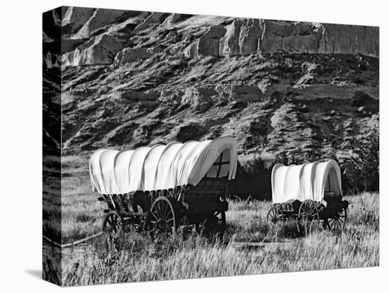 Nebraska, Scotts Bluff National Monument. Covered Wagons in Field-Dennis Flaherty-Premier Image Canvas