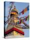 Nepal, Kathmandu, Swayambhunath Stupa and fluttering prayer flags in motion-Merrill Images-Premier Image Canvas