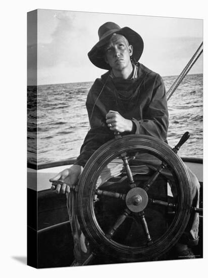 Newport Bermuda Sailing Race: Young Man Attending the Wheel of a Sailboat-Peter Stackpole-Premier Image Canvas