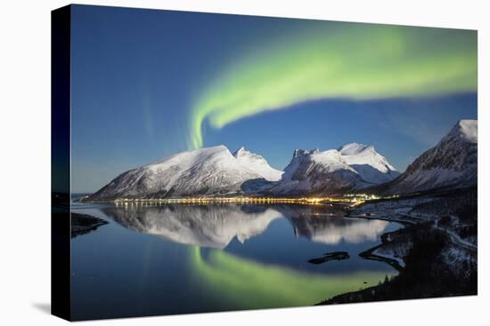 Northern lights and stars light up the snowy peaks reflected in sea, Bergsbotn, Senja, Norway-Roberto Moiola-Premier Image Canvas