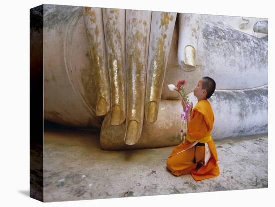 Novice Buddhist Monk Kneeling Beneath the Phra Atchana Buddha Statue, Sukhothai Province, Thailand-Gavin Hellier-Premier Image Canvas