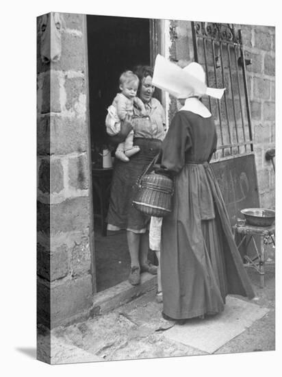 Nun from the Order of Sisters of Charity Visiting a Destitute Family with Supplies-null-Premier Image Canvas