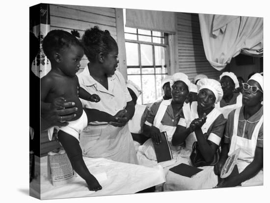 Nurse/Midwife Maude Callen Holds Baby and Teaches Class in Midwifery How to Look for Abnormalities-W^ Eugene Smith-Premier Image Canvas