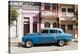 Old blue American car parked in front of old buildings, Cienfuegos, Cuba-Ed Hasler-Premier Image Canvas