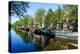 Old gabled buildings reflecting in a canal, Amsterdam, North Holland, The Netherlands-Fraser Hall-Premier Image Canvas