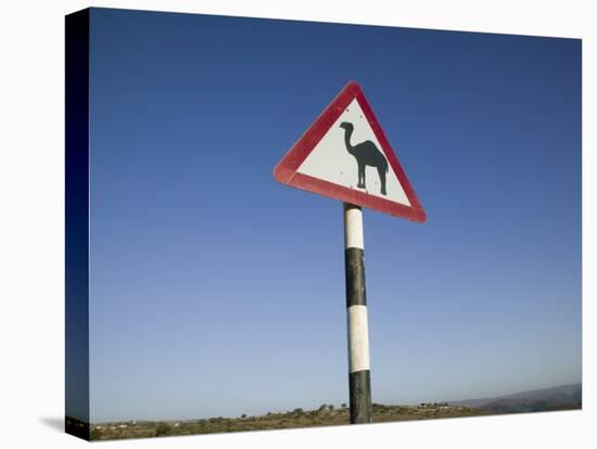 Oman, Dhofar Region, Salalah, Camel Crossing Sign in the Dhofar Mountains-Walter Bibikow-Premier Image Canvas