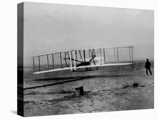 Orville Wright Taking Plane For 1st Motorized Flight as Brother Wilbur Wright Looks at Kitty Hawk-null-Premier Image Canvas
